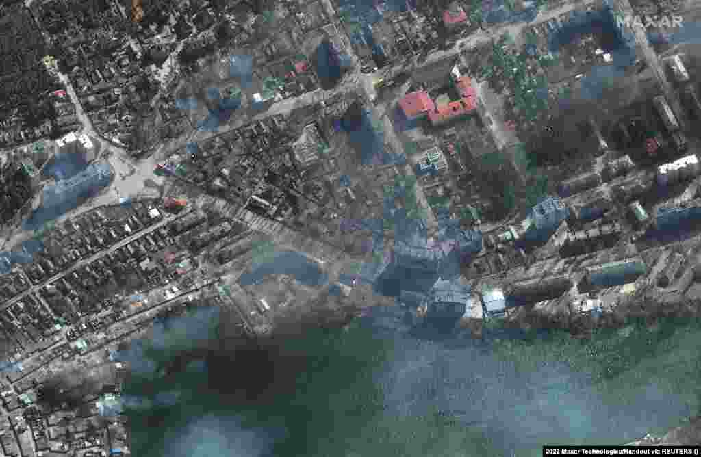 Residential buildings burn in the encircled, besieged city of Mariupol on March 21.