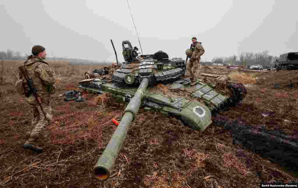 Ukrainian soldiers on a Russian tank that got bogged down in the Chernihiv region on April 1. 