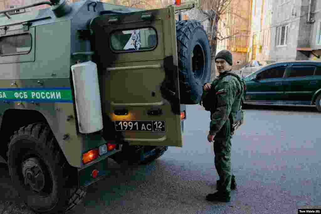 A Russian peacekeeping soldier stands next to a vehicle with a "Z" marking associated with support for the invasion of Ukraine. Photographer Tom Videlo says many Karabakh locals see the ongoing inaction of Russian peacekeepers to clear the Lachin road as a calculated political move to exert pressure on Yerevan for Russia's own geopolitical goals. 