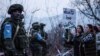 Government-backed Azerbaijani protesters identifying themselves as environmentalists stand in front of Russian peacekeepers last month.
