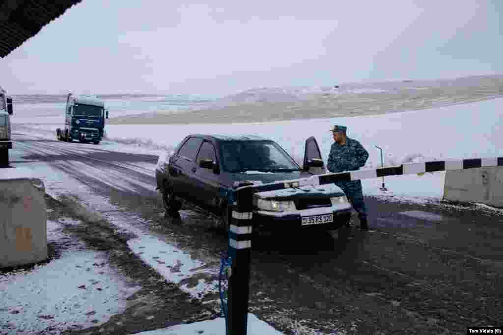 An ethnic Armenian policeman speaks to a driver at the Tegh checkpoint. Armenian authorities began preventing anyone except local villagers from proceeding past this post shortly after the blockade began on December 12. 