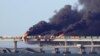 Black smoke billows from a fire on the Kerch bridge that links Crimea to Russia after a truck exploded near Kerch on October 8, 2022.