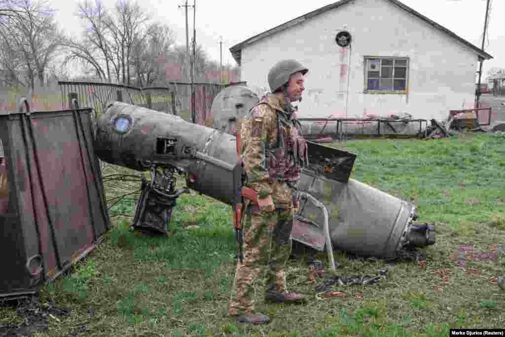 A Ukrainian soldier next to the remains of a missile near Barvinkove on April 11. 