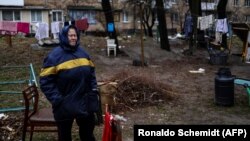 An elderly woman cries near her house in Bucha, northwest of Kyiv, on April 2. The town's mayor said 280 people had been buried in a mass grave and that the town was littered with corpses.