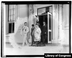 Fatima leaves the White House with her three sons and an unidentified naval officer after meeting with President Harding. The U.S. Library of Congress photo caption incorrectly identifies the official as Weyman/Weinberg.