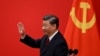 Chinese President Xi Jinping waves after introducing the members of the Chinese Communist Party's new Politburo Standing Committee, the country's top decision-making body, in the Great Hall of the People in Beijing on October 23.