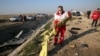 Rescue teams recover debris from a field at the crash site on January 8.