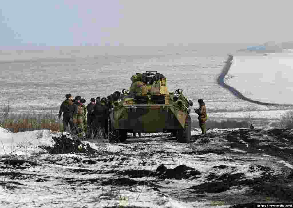 Russian soldiers stand next to a BTR-82 armored personnel carrier during drills at the Kuzminsky range on January 26. 