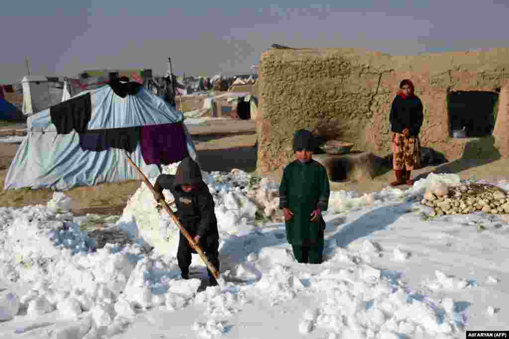 Children at a camp for internally displaced people (IDPs) shovel snow near their tents in the Nahr-e-Shahi district of Balkh Province, near Mazar-i-Sharif, on January 17. Kabul and several other provinces have seen record-low temperatures since January 10, with Ghor in the central region reaching the lowest reading of -33 Celsius (-27 Fahrenheit). 