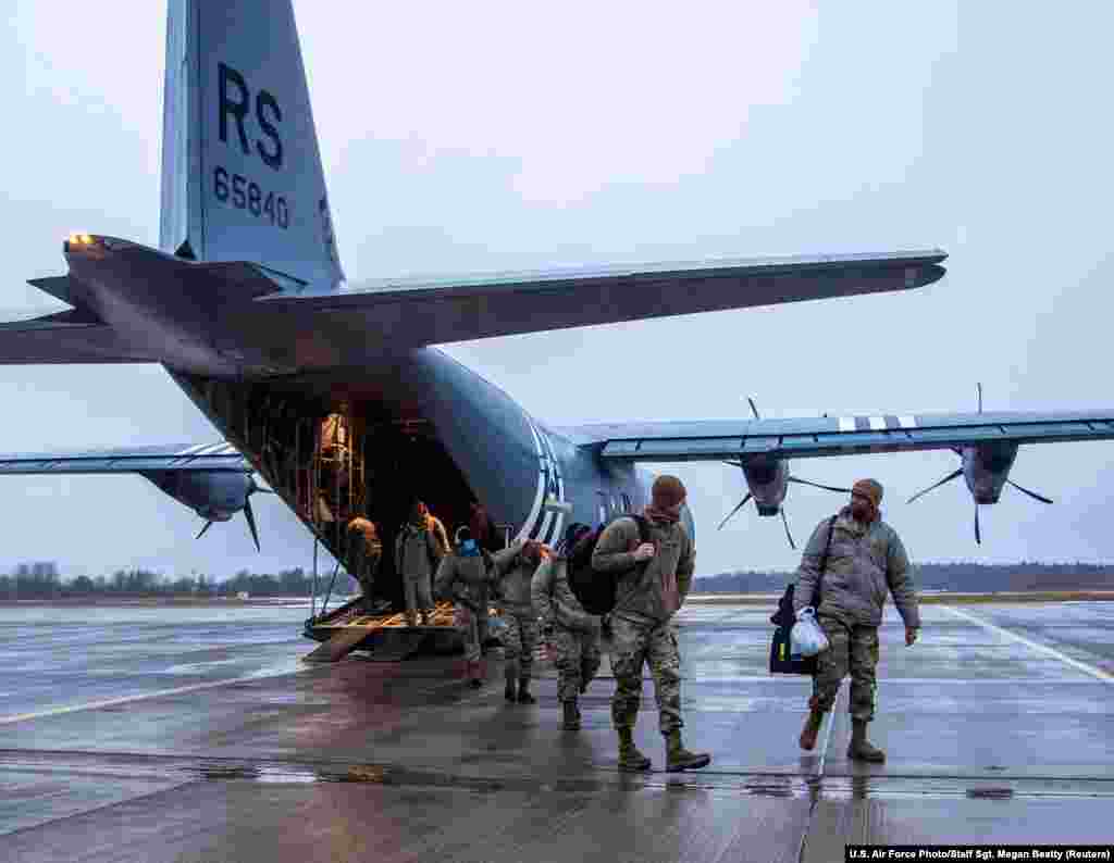 U.S. and British airmen arrive at Estonia's Amari Air Base on January 24. The servicemen traveled from Germany to support a NATO "air policing" mission. The photo was released on January 26. 