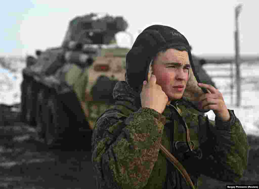 A member of a Russian military vehicle crew puts on his helmet during drills at the Kuzminsky range on January 26. 