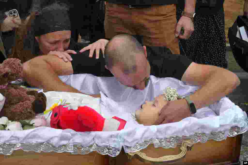 Artem Dmitriyev says farewell to his daughter Liza, a 4-year-old killed by a Russian missile strike on Vinnytsya on July 17. Liza was among 23 people killed in the attack, including two boys age 7 and 8. Liza&#39;s mother, Iryna Dmytriyeva, was among the scores injured.