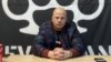  Levijatan's leader, Pavle Bihali, in his office in downtown Belgrade with the group's logo behind him.