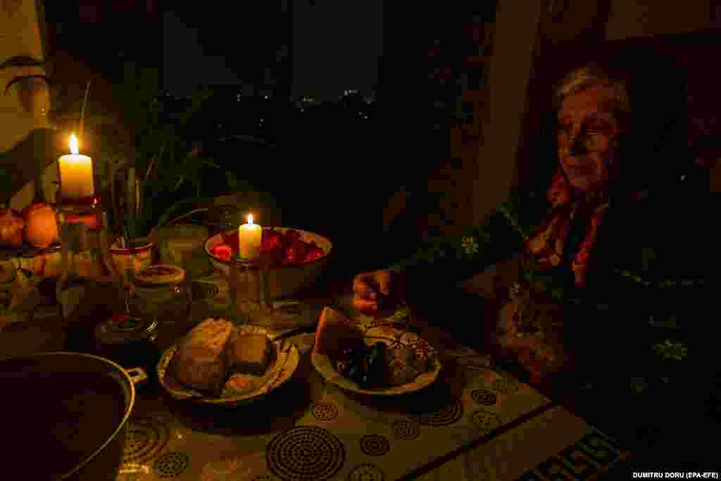 A woman eats her dinner by candlelight in Chisinau on October 25. &quot;It&#39;s a daily challenge to supply the country with energy. A family is paying 70 to 75 percent of its incomes on [gas and electricity] bills,&quot; Sandu said in a recent address to parliament in neighboring Romania. &nbsp;