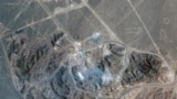 Smoke is seen rising from impact craters left by the US strike on Iran's fuel enrichment facility at Fordow in a satellite image taken on June 22.