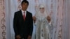 Newly married Anvar and Nargiz after their traditional wedding. The Tajik government is wary of a revival of Muslim customs, fearing the rise of radical Islam and the return of young people who went to fight in Syria.
