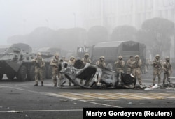 Troops are seen on Almaty's main square, where hundreds of people protested against the government after the authorities' decision to lift price caps on liquefied petroleum gas, on January 6, 2022.
