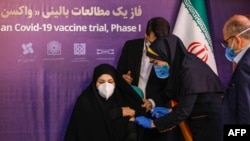 A woman receives an injection during the first trial phase of a locally made Iranian vaccine for COVID-19 in Tehran on December 29.