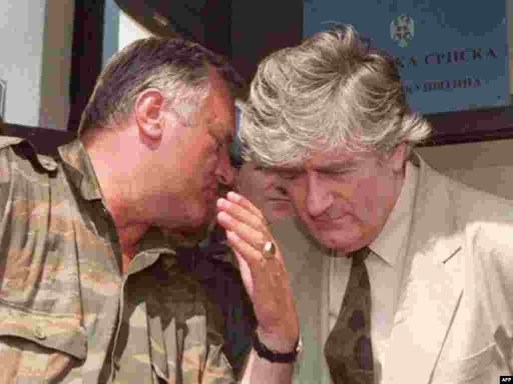 In a photo dated August 5, 1993, former Bosnian Serb military commander Ratko Mladic is shown speaking to Bosnian Serb leader Radovan Karadzic in Pale.