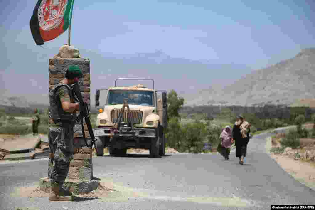 An Afghan soldier watches from a checkpoint in Laghman Province on July 8 after Afghanistan&#39;s security forces reportedly cleared the area of Taliban militants.&nbsp; &nbsp;