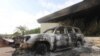A burned car is seen in front of the U.S. Consulate in Benghazi, Libya, after it was attacked and set on fire by gunmen on September 11, 2012.