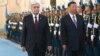 Kazakh President Qasym-Zhomart Toqaev (left) welcomes Chinese leader Xi Jinping to Astana on July 2 for a state visit and two-day SCO summit. 