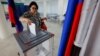 A voter casts a ballot at a polling station during local elections held by the Russian-installed authorities in Russian-controlled Donetsk on September 8.