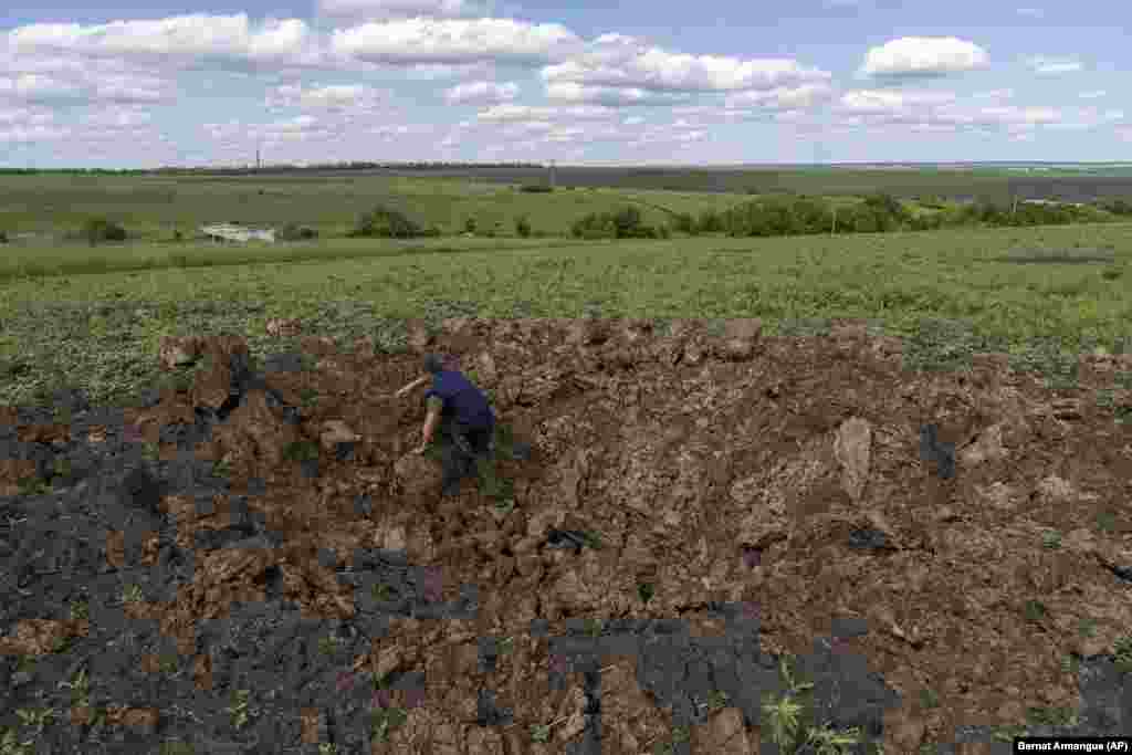 A farm worker climbs out of a crater caused by shelling in Cherkaska Lozova. The European Parliamentary Research Service reports that Russia and Ukraine supply more than half of cereal imports in northern Africa and the Middle East, while countries in eastern Africa import 72 percent of their cereals from Russia and 18 percent from Ukraine. 