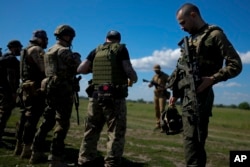 Otoy (right) attends a training session at a shooting range on the outskirts Kyiv in June 2022.