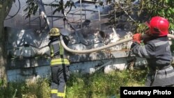Firefighters extinguish a blaze at a logistics hub after a Russian missile strike on Odesa on June 20.