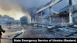 Rescuers work at a site of a shopping mall hit by a Russian missile strike in Kremenchuk on June 27.