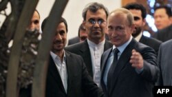 Russian President Vladimir Putin (right) gestures as he speaks with his Iranian counterpart Mahmud Ahmadinejad (left) during a meeting in Beijing in June 2012.