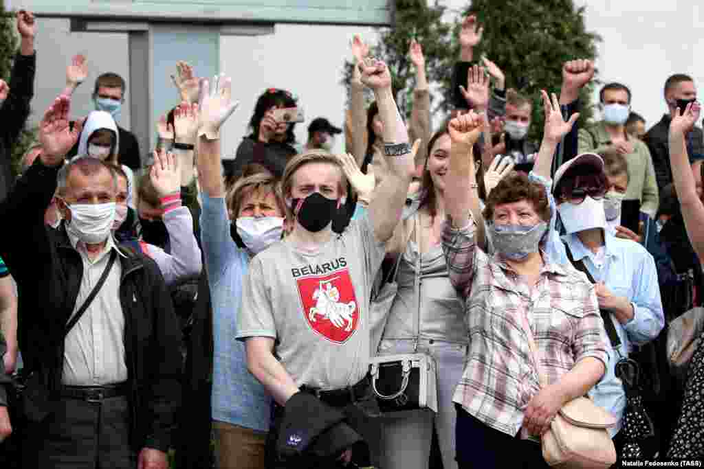 People in face masks attend a rally near the Komarovka Market in Minsk on June 7. The rally was organized by activists to collect signatures in support of opposition presidential hopefuls. 
