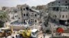 Rescue teams clear rubble in a neighbourhood in the northern Israeli village of Tamra, June 15, 2025.