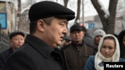 Serikzhan Bilash speaks to reporters outside a courthouse in Almaty on February 13.