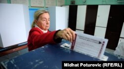 A voter casts her ballot in Sarajevo.