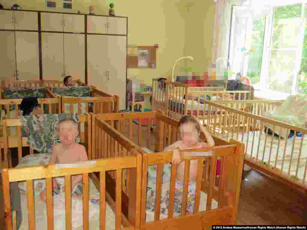 Roman K., 18, (left) and Lyuba P., 15, in a "lying-down" ward of an orphanage for children with disabilities in northwest Russia. Roman K. was awaiting transfer to an institution for adults with disabilities. A pediatrician specializing in the health of children with disabilities told Human Rights Watch that, based on photographs, both Roman K. and Lyuba P. appeared significantly underdeveloped for their ages, a possible result of lack of adequate nutrition, stimulation, and health care.