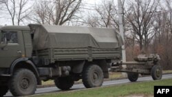 A truck tows a 122-millimeter artillery piece on a main road east of Donetsk on November 11.