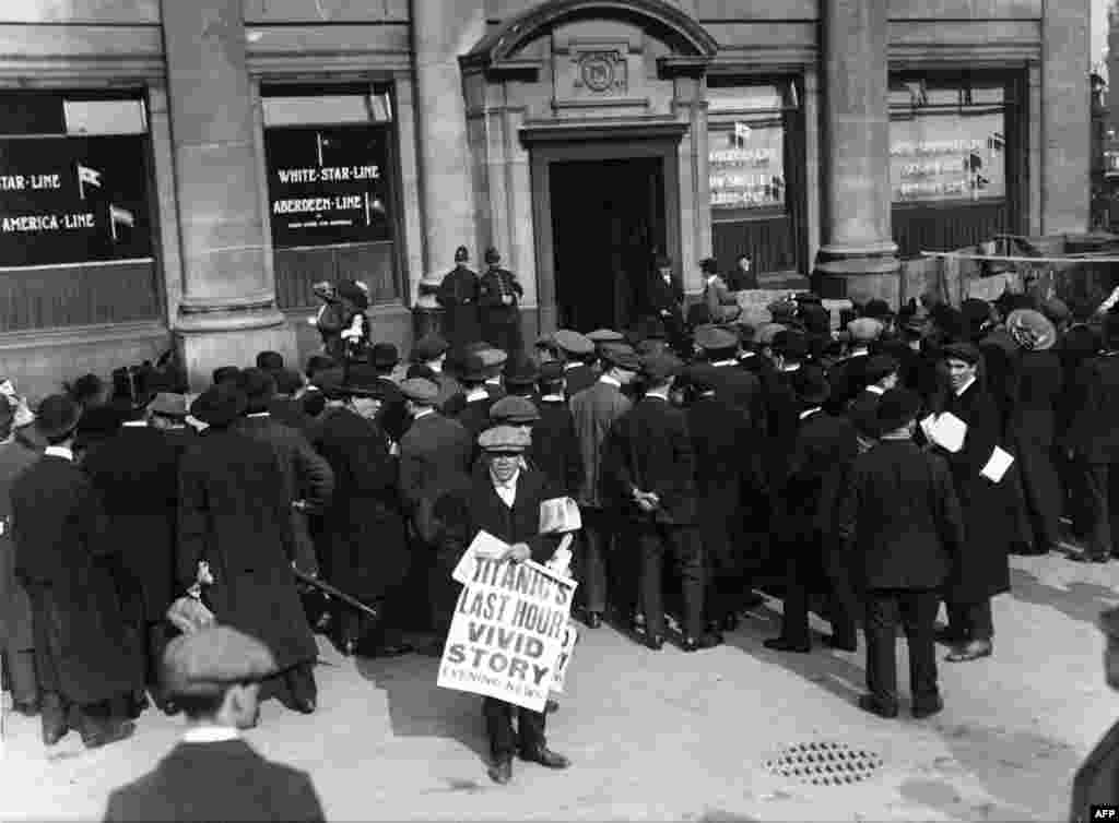 A newsboy hawks a special edition outside the offices of the White Star Line in London after news of the sinking of the "Titanic" hit the streets.