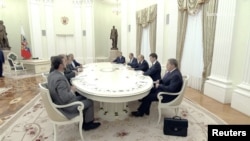 Russian President Vladimir Putin meets with Iranian Foreign Minister Abbas Araqchi in Moscow on June 23.
