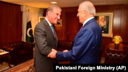 Pakistani Foreign Minister Shah Mahmood Qureshi (left) receives U.S. envoy Zalmay Khalilzad at the Foreign Ministry in Islamabad on January 18.