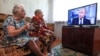 Elderly women watch a live broadcast of Russian President Vladimir Putin's annual question-and-answer session in the village of Yelna, Ivanovo region, on June 7.