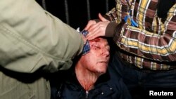 Fostul ministru de interne al Ucrainei și șef al opoziției Iuri Iuțenko primind îngrijiri după ce a fost rănit de poliție, 10 ianuarie 2014