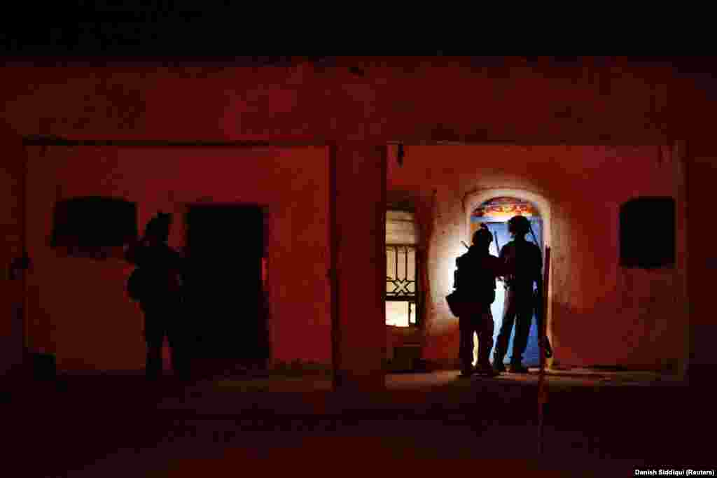 Members of the Afghan special forces search a house during the combat mission against the Taliban. The extremist Islamist group is known for attacking and then melting away, making the fight against the militants extremely difficult in populated areas. 
