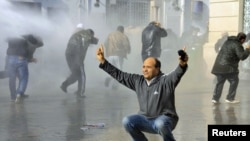 Security forces use water canons to disperse protesters in downtown Tunis on January 17.