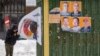A man walks past election campaign posters in Greenland's capital, Nuuk, on March 8. 