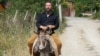 Russian businessman German Sterligov rides a donkey in Nagorno-Karabakh, 7Jul2015.