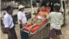 Rescue workers in the Myanmar capital, Naypyitaw, attend to an injured man who was trapped under a building following an earthquake on March 28.