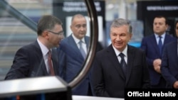 Uzbekistan President Shavkat Mirziyoev (second-right) visits a factory owned by Texnopark, which has controversially won a tender for installing millions of gas meters. 
