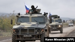 NAGORNO-KARABAKH -- Armored vehicles of Russian peacekeepers move along the road towards Agdam from their check point outside Askeran, November 20, 2020